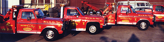 Older Illinois Valley Towing red wrecker lineup, Peoria lettering on the doors