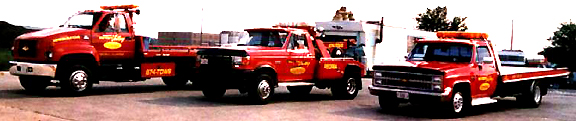 Illinois Valley Towing red wreckers and a rollback in the yard