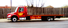 Red Freightliner flatbed, Call 674-TOWS on the rail