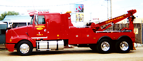 Red Kenworth-style wrecker, oval on the door