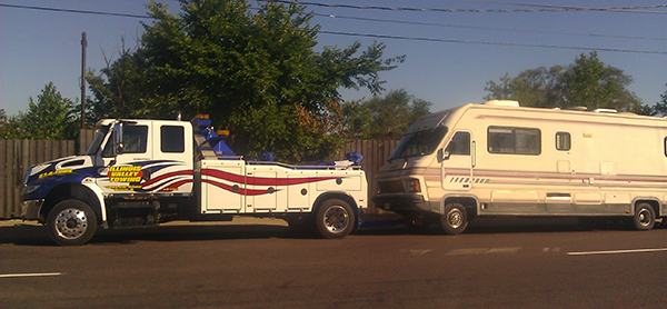 2012 Illinois Valley Towing wrecker towing a motorhome